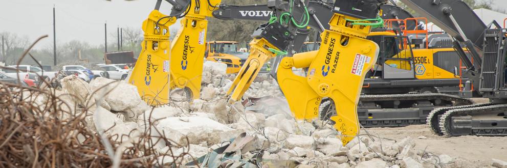 Yellow Genesis shears and processors processing concrete